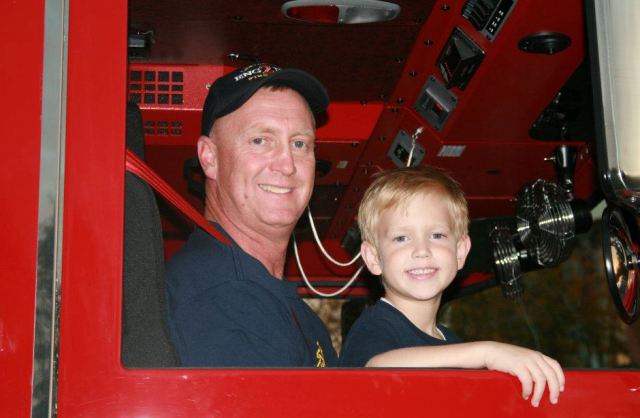 Lt. Col. Rob Larkin treating his son Aidan to a trip in a fire engine in 2011! Photo courtesy of the Larkin family.